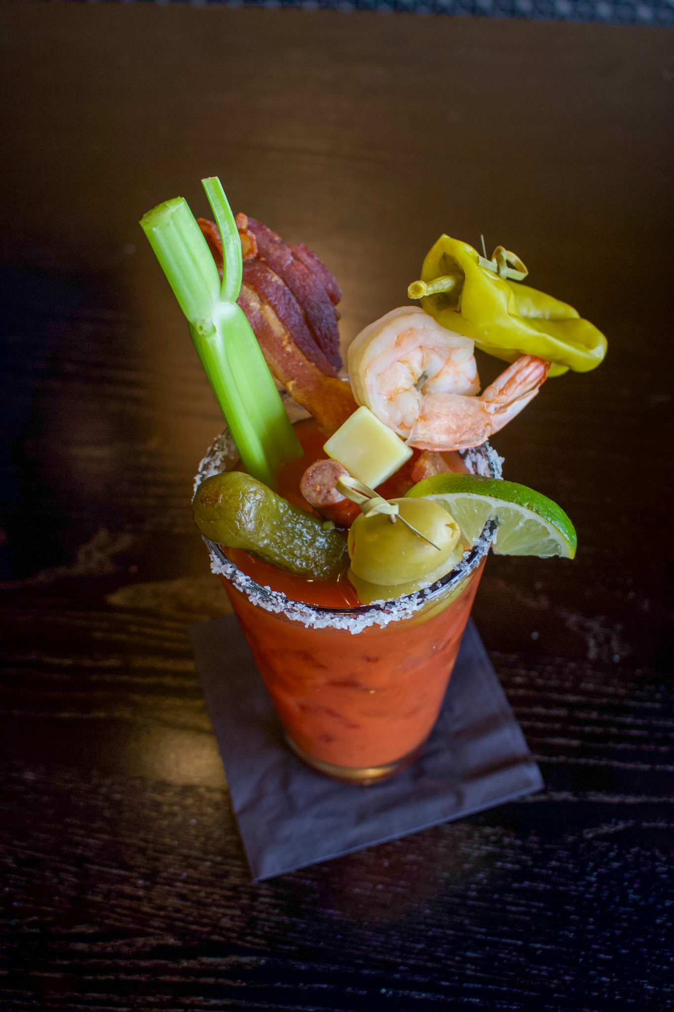 bloody mary cocktail with vegetables, shrimp and pickle