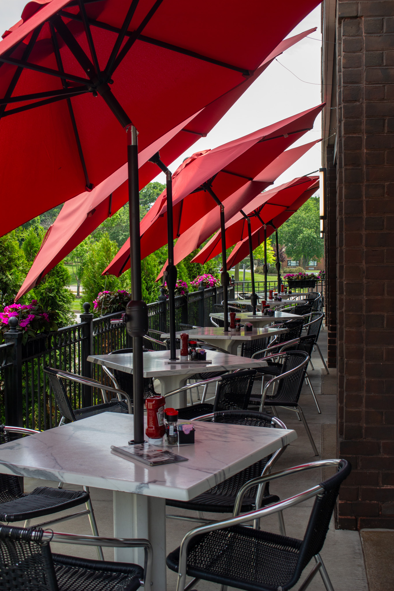 red umbrellas over patio tables
